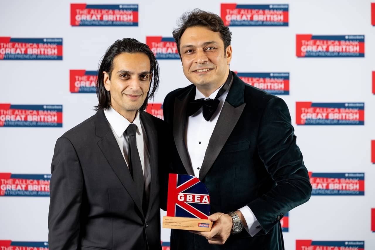 Two men holding a GBEA trophy at the Great British Entrepreneur Awards